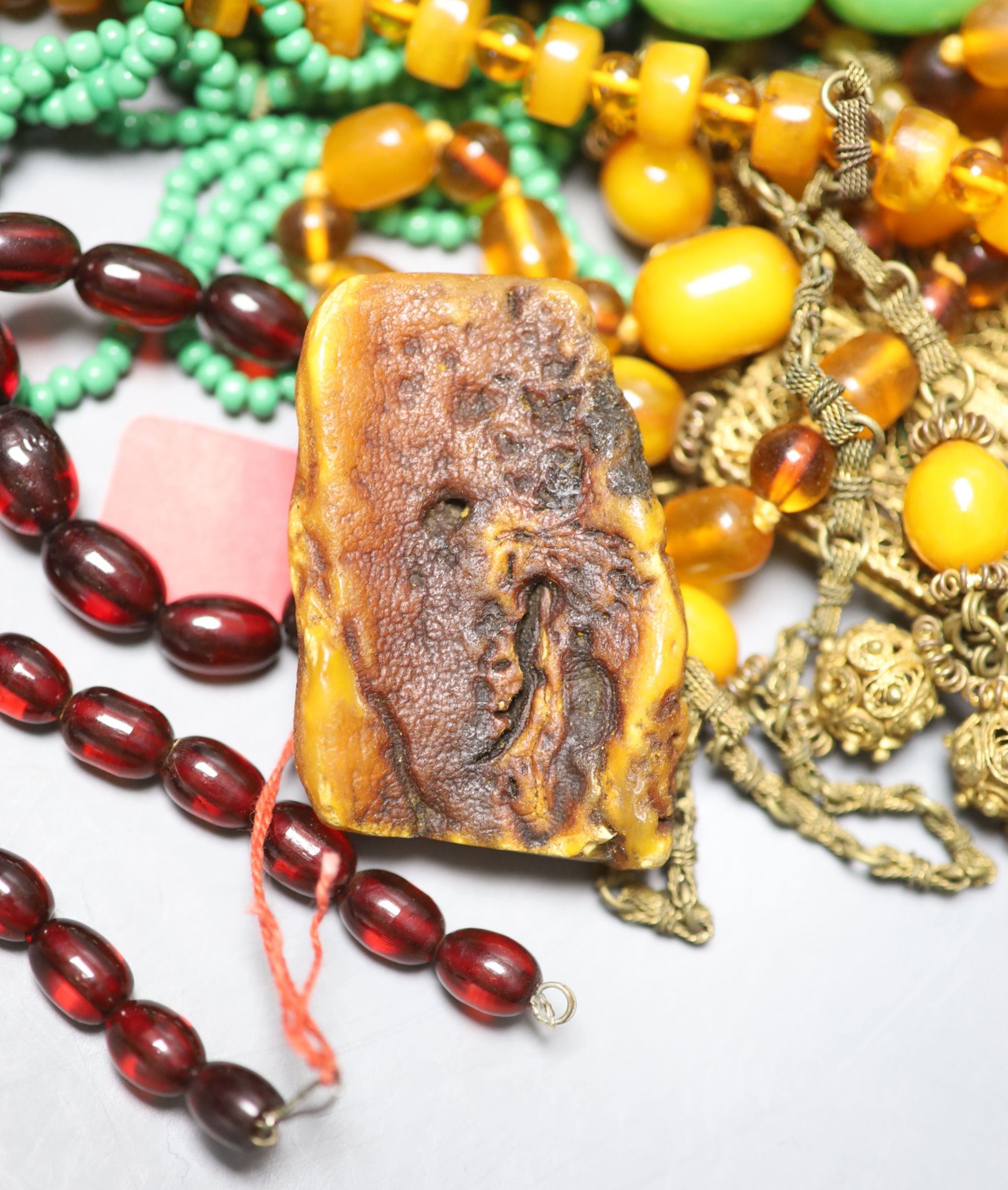 A group of assorted costume jewellery including faux amber etc.